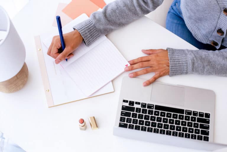 Woman writing a blog post with SEO keywords
