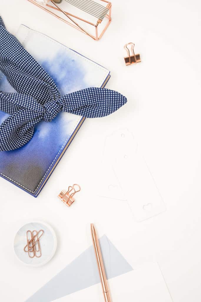 Blue flatlay with keyboard items and notebooks